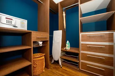 a room with blue walls and wooden cabinets at Amanta Hotel & Residence Ratchada in Bangkok