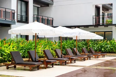 a row of chairs and umbrellas on a patio at Amanta Hotel & Residence Ratchada in Bangkok