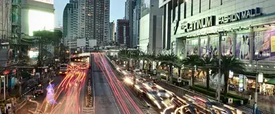 a busy city street at night with cars at PR Place Hotel in Bangkok
