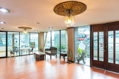 a large room with glass doors and chandeliers at SK Boutique Mahanakhon in Bangkok