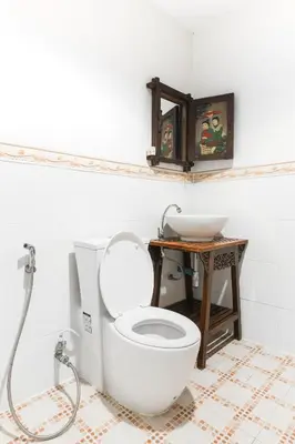 a bathroom with a white toilet and a sink at SK Boutique Mahanakhon in Bangkok