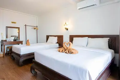 a bedroom with two beds with a towel on them at SK Boutique Mahanakhon in Bangkok