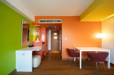 a room with colorful walls and a table and chairs at Veronica Residence in Bangkok