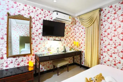 a bedroom with a vanity with a mirror and a mirror at Diamond City Hotel SHA Certified in Bangkok