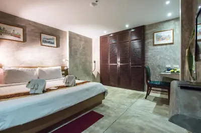 a hotel room with a bed and a desk at Buddy Boutique Inn in Bangkok