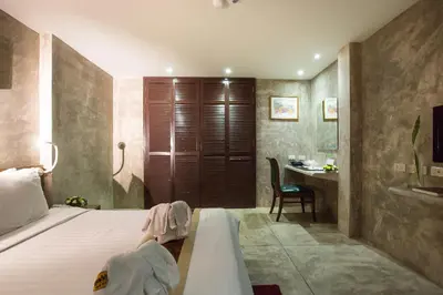 a bedroom with a bed and a desk and a sink at Buddy Boutique Inn in Bangkok