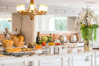 a buffet of food on a table in a kitchen at Kalanan Riverside Resort in Nonthaburi