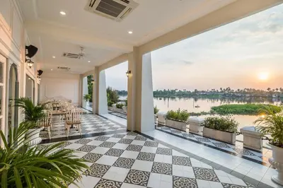 a view of the water from the balcony of a house at Kalanan Riverside Resort in Nonthaburi