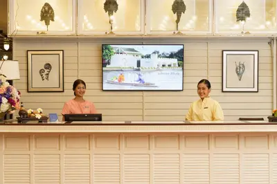 two women sitting at a counter in a restaurant at Kalanan Riverside Resort in Nonthaburi