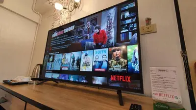 a large flat screen tv sitting on a table at Khaosan Art Hotel in Bangkok