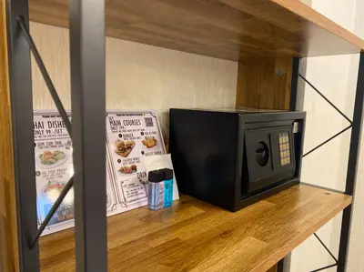 a microwave sitting on top of a wooden shelf at Khaosan Art Hotel in Bangkok