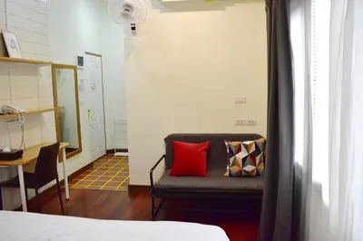 a room with a couch with two pillows on it at Greenery Hostel in Bangkok