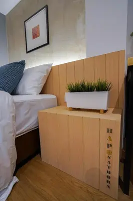 a bedroom with a bed and a table with plants on it at Hap@sathorn in Bangkok