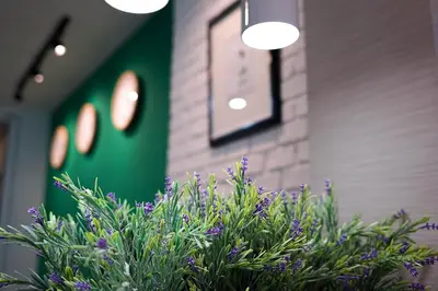 a plant with purple flowers in front of a building at Hap@sathorn in Bangkok