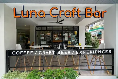 a store front of a line craft bar with tables and chairs at Hap@sathorn in Bangkok