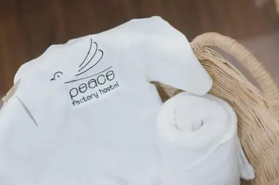 a white towel with the words peoria pharmacy network on it at Peace Factory Hostel in Bangkok