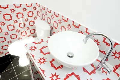 a bathroom with a sink and a toilet at Smile Inn in Bangkok