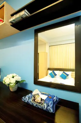 a mirror on a table in a room at Smile Inn in Bangkok