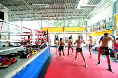 a group of men standing in a boxing ring at Smile Inn in Bangkok