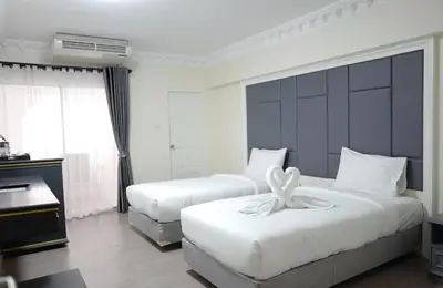 a hotel room with two beds and a piano at Romance Hotel Sukhumvit 97 in Bangkok