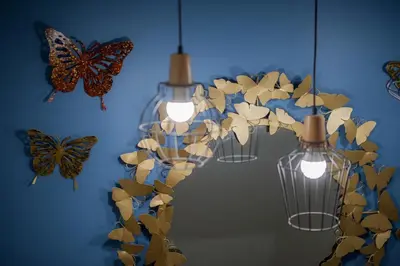 a group of butterflies hanging on a blue wall at The Moon Night Hotel in Bangkok