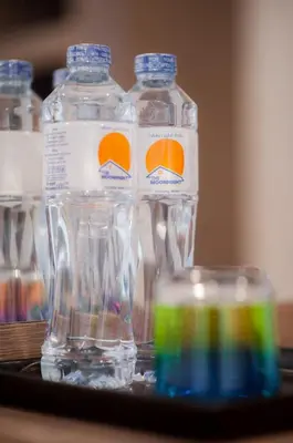 a group of bottles of water sitting on a tray at The Moon Night Hotel in Bangkok
