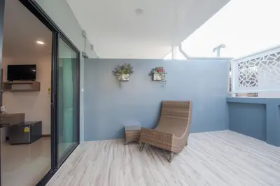 a chair in a room with a blue wall at The Moon Night Hotel in Bangkok