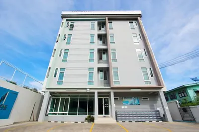 a tall white building with the front entrance at NW Apartment Lasalle 59 in Bangna