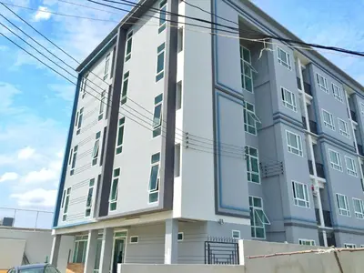 a large white building with windows on the side of it at NW Apartment Lasalle 59 in Bangna