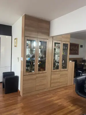 a room with a large wooden cabinet with glass doors at Penthouse by JJ in Bangkok
