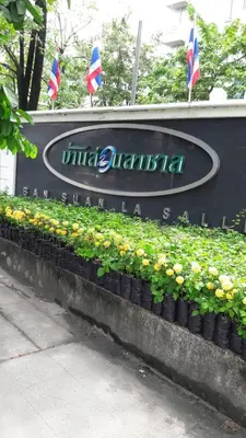 a sign for the university of bangalore with flags at Penthouse by JJ in Bangkok