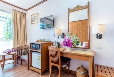 a room with a desk and a mirror at New Siam Riverside in Bangkok