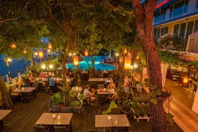 an overhead view of a restaurant with a pool at night at New Siam Riverside in Bangkok