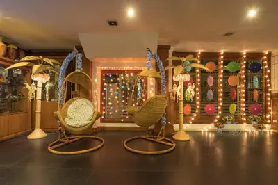 a room with wicker chairs and christmas lights at New Siam Riverside in Bangkok