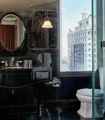 a bathroom with a sink and a mirror and a toilet at Hotel Muse Bangkok, Autograph Collection by Marriott in Bangkok