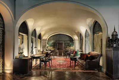 a living room with a couch and a table at Hotel Muse Bangkok, Autograph Collection by Marriott in Bangkok