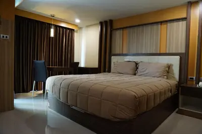 a bedroom with a large bed in a room at Central Mansion in Bangkok