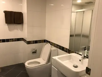 a bathroom with a toilet and a sink at Central Mansion in Bangkok