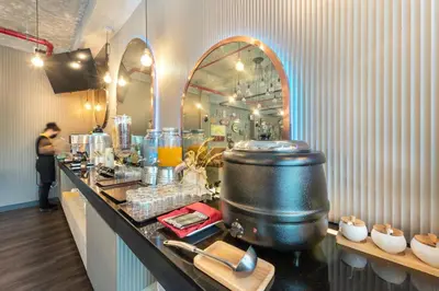 a kitchen with a counter with a large pot on it at Qiu Hotel Sukhumvit - BTS On Nut Station in Bangkok