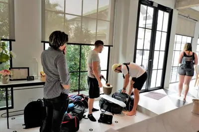 a group of people standing in a room with luggage at Bedspread Hostel in Bangkok