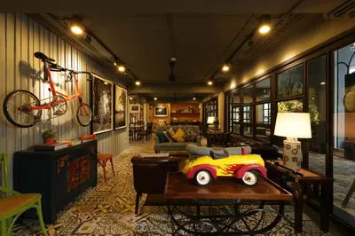 a living room with a table with a toy car on it at Nandha Hotel in Bangkok