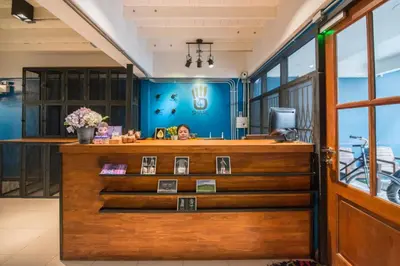 a barber shop with a blue wall at 4SHARE Hostel in Bangkok