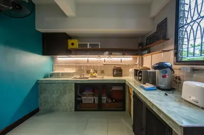 a kitchen with a sink and a counter top at 4SHARE Hostel in Bangkok