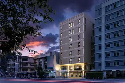 a rendering of a building at dusk at Travelier Hostel in Bangkok