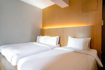 two beds sitting next to each other in a room at Travelier Hostel in Bangkok