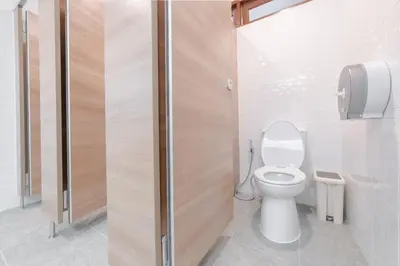 a bathroom with a toilet and a shower stall at Tiny Taladnoi Hostel in Bangkok