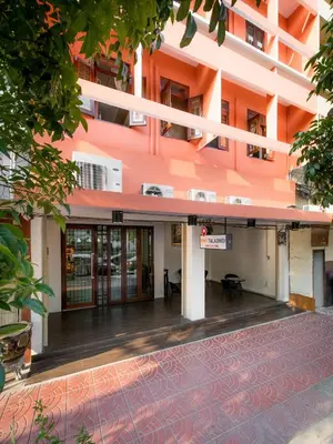 an external view of a building with an empty courtyard at Tiny Taladnoi Hostel in Bangkok