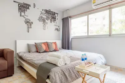 a bedroom with a bed and a table with towels on it at Popular Condo C5 IMPACT in Pak Kret