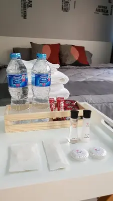 a table with two bottles of water and cups on it at Popular Condo C5 IMPACT in Pak Kret
