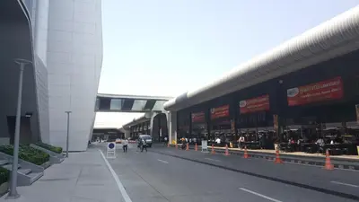 a large building with people walking down a street at Popular Condo C5 IMPACT in Pak Kret